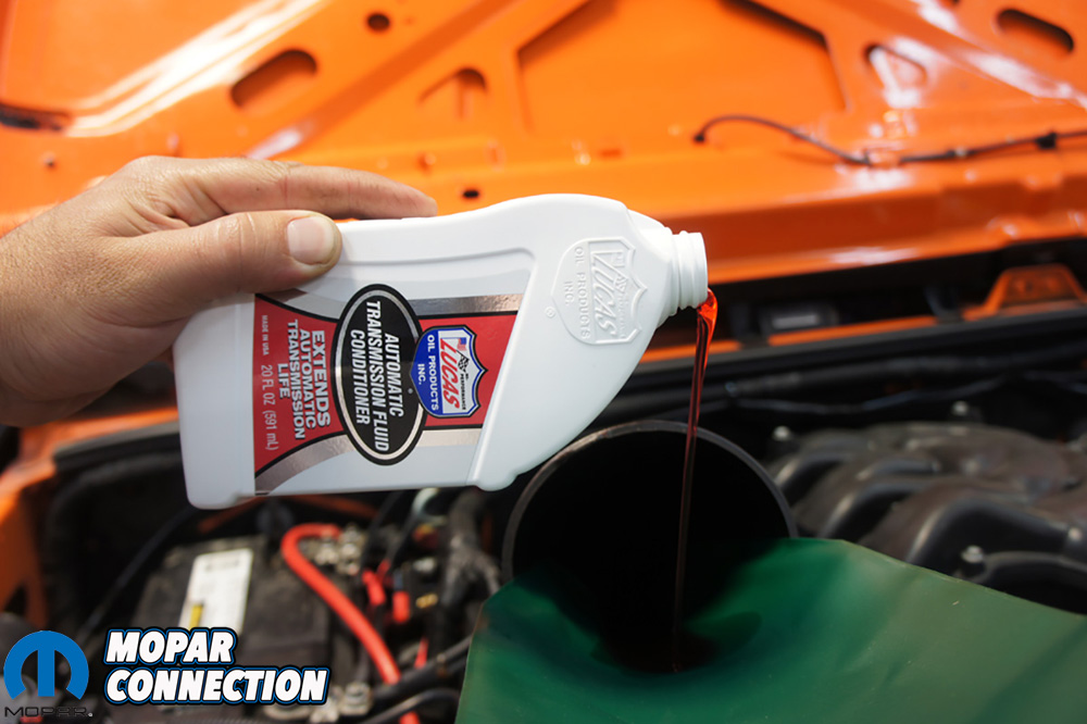 We slowly poured our fluids in and started with a quart of the Lucas Oil ATF Conditioner first.
