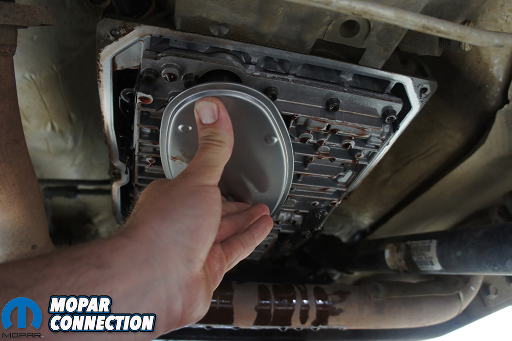 We pressed our new filter into our transmission and get ready to bolt the pan back on.