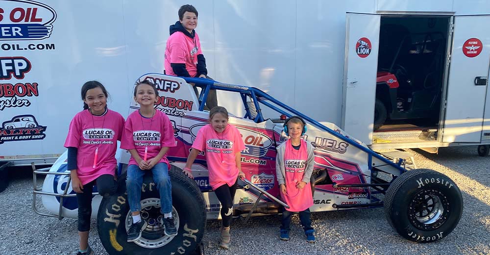 Excited kids with the Pink 69 Silver Crown Dirt Champ Car.